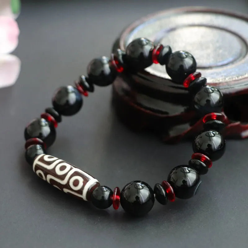 Black agate dzi bead bracelet with 11mm geometric beads and hand-woven construction