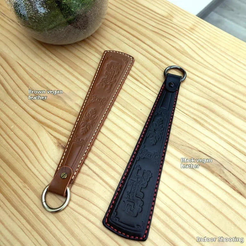 Leather hand massage racket with stainless steel panel, 25.5cm long, 142g, in black or brown
