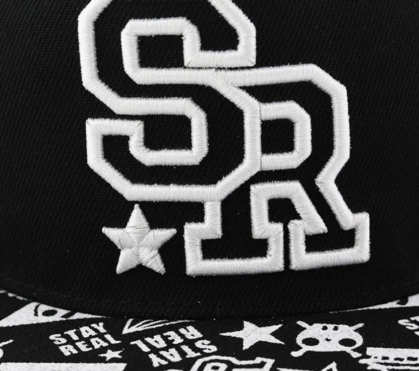 A black cotton baseball cap with embroidered lettering on the front, showing the adjustable strap at the back.