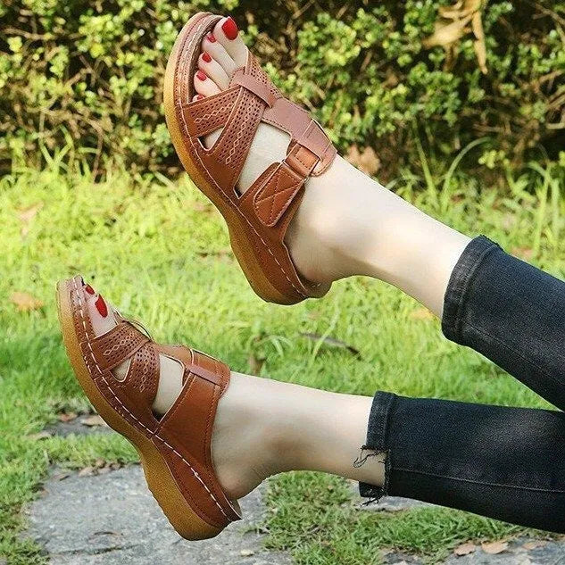Women's black wedge sandals with a peep toe and Velcro fastening strap.