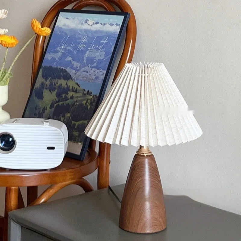 Nordic style ceramic table lamp with a pleated fabric shade on a bedside table