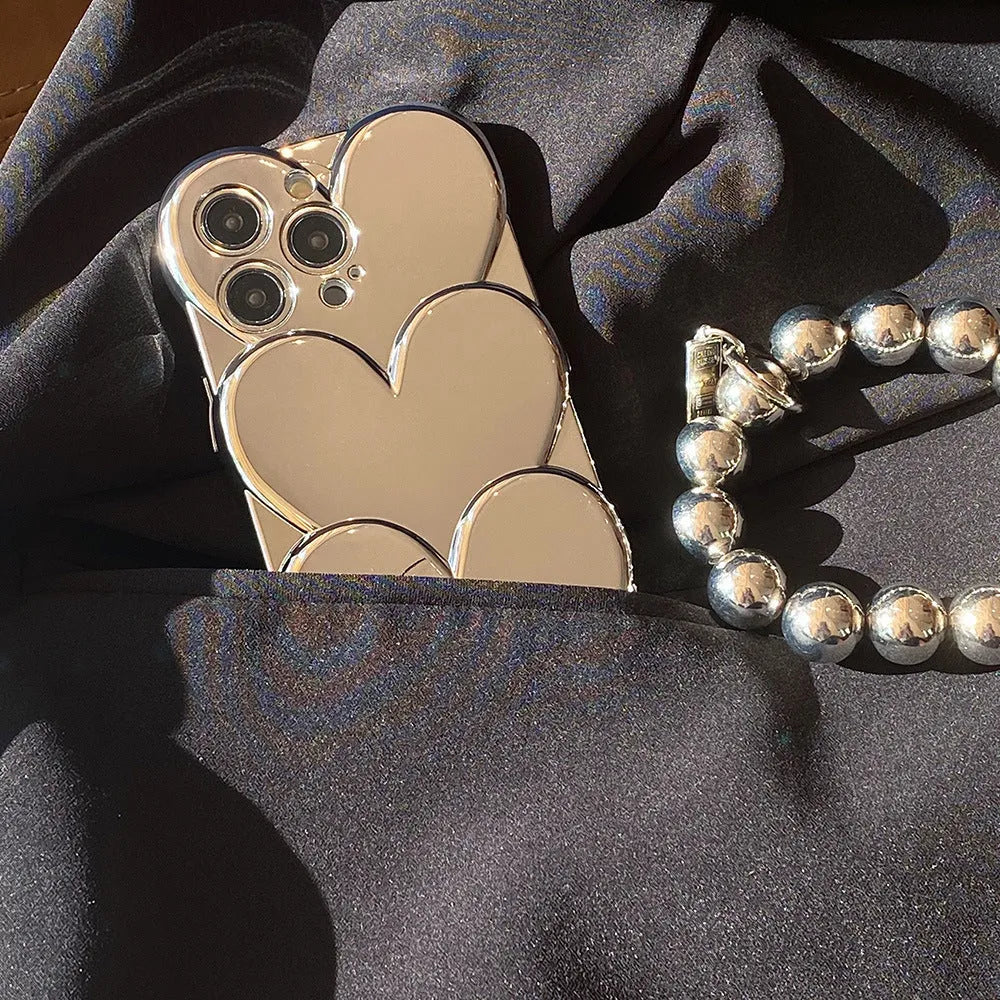 Soft TPU iPhone case with a silver electroplated love design on the back, shown next to a matching bracelet.