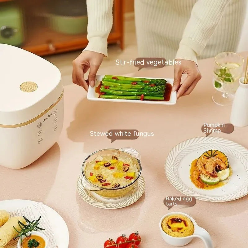 White or beige 3L rice cooker with black inner pot, rice scoop, measuring cup and steamer basket