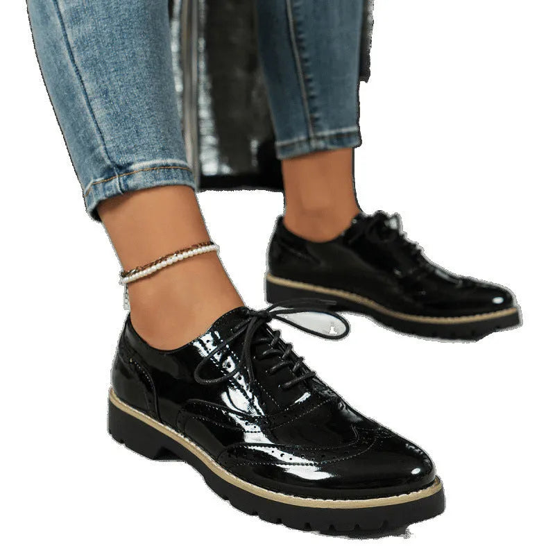 Women's black loafers with mirror sequin details, wedge heel, and lace-up oxford styling on a white background