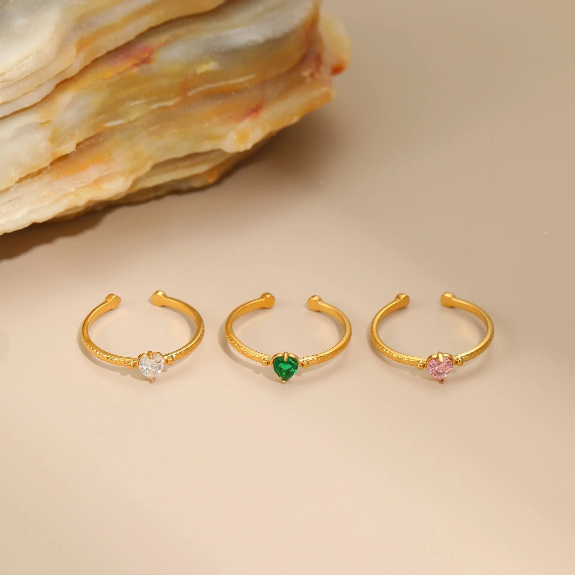 Heart-shaped open-ended ring with geometric design and inlaid zircon detail in stainless steel