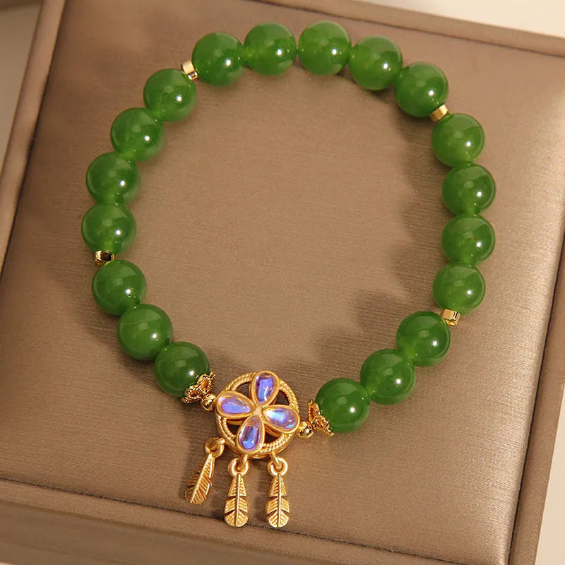 Green jasper crystal four-leaf clover dream catcher pendant bracelet on a natural cotton cord.