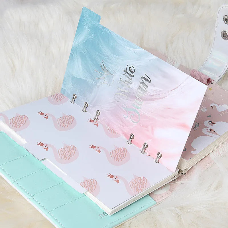 Six white A6 separator pages with colour printing beside Swan handbook