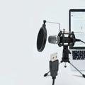 Black mini condenser microphone on an aluminium stand with 3.5mm and USB cables for computer or phone.