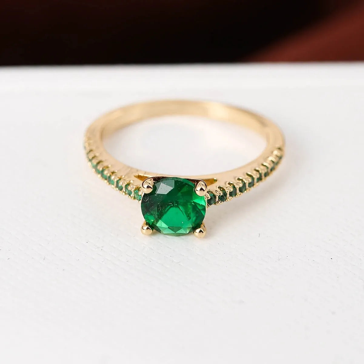 A hexagonal zircon fashion ring made from copper, shown in an electroplated gold rose red finish.
