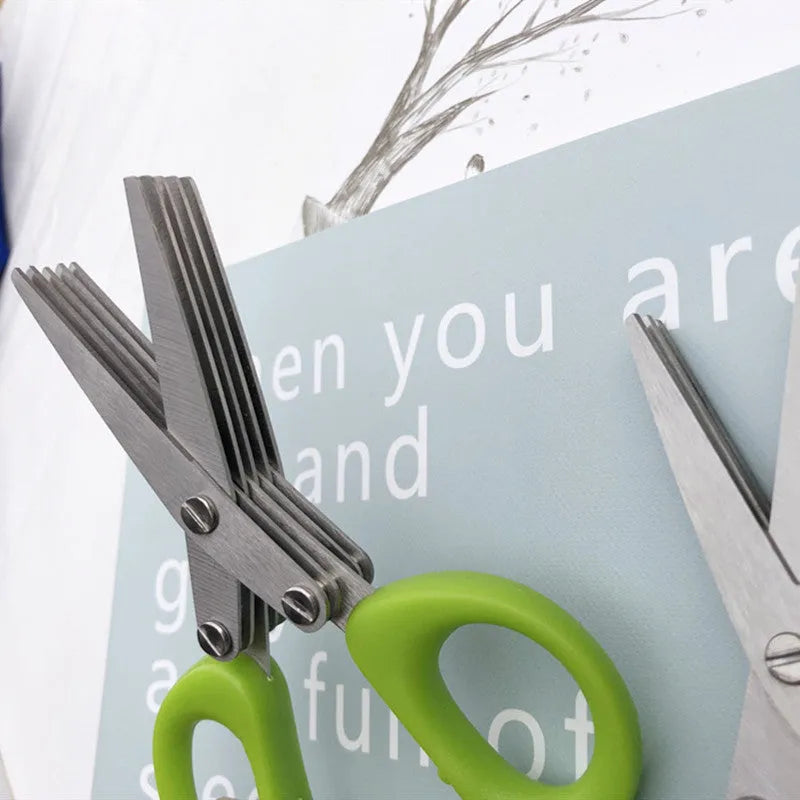 Green multi-layer stainless steel kitchen scissors for cutting herbs and green onions.