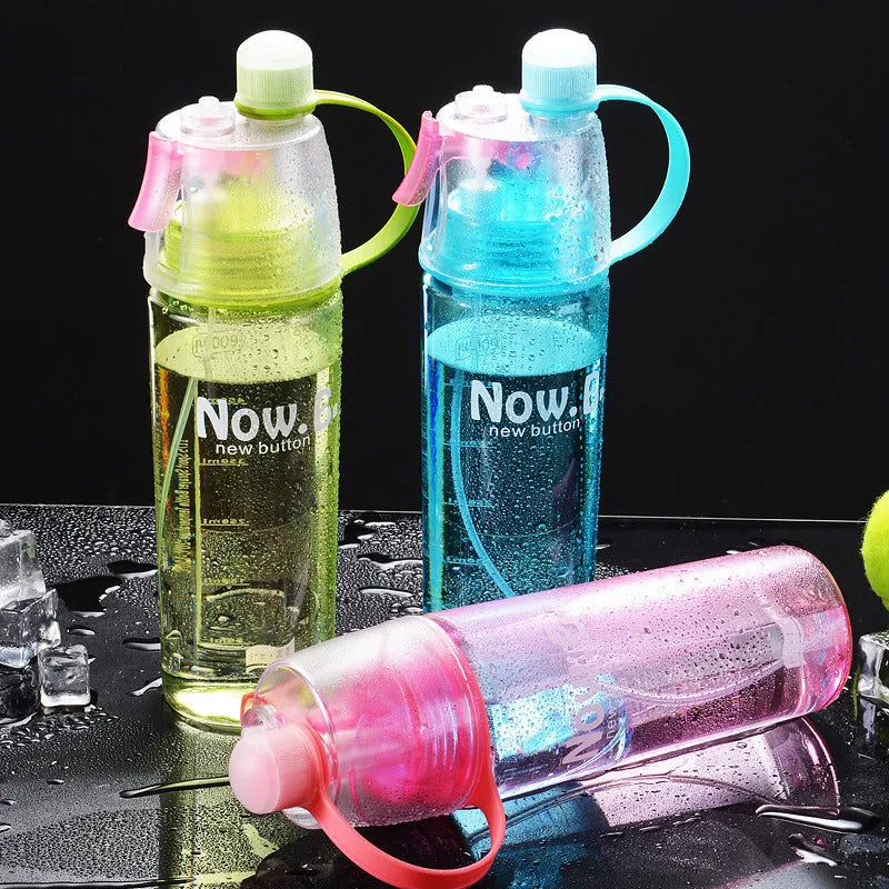 Green portable sports mist spray cup with handle, spray nozzle, and visible water level scale.