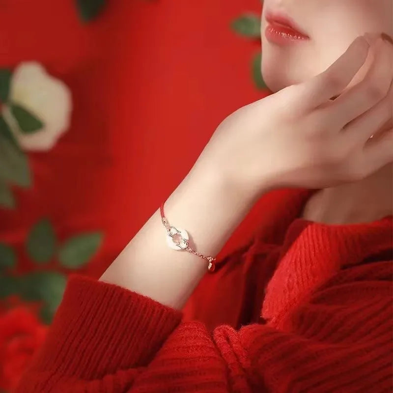Red rope women's bracelet with peace buckle clasp and festive koi fishtail design