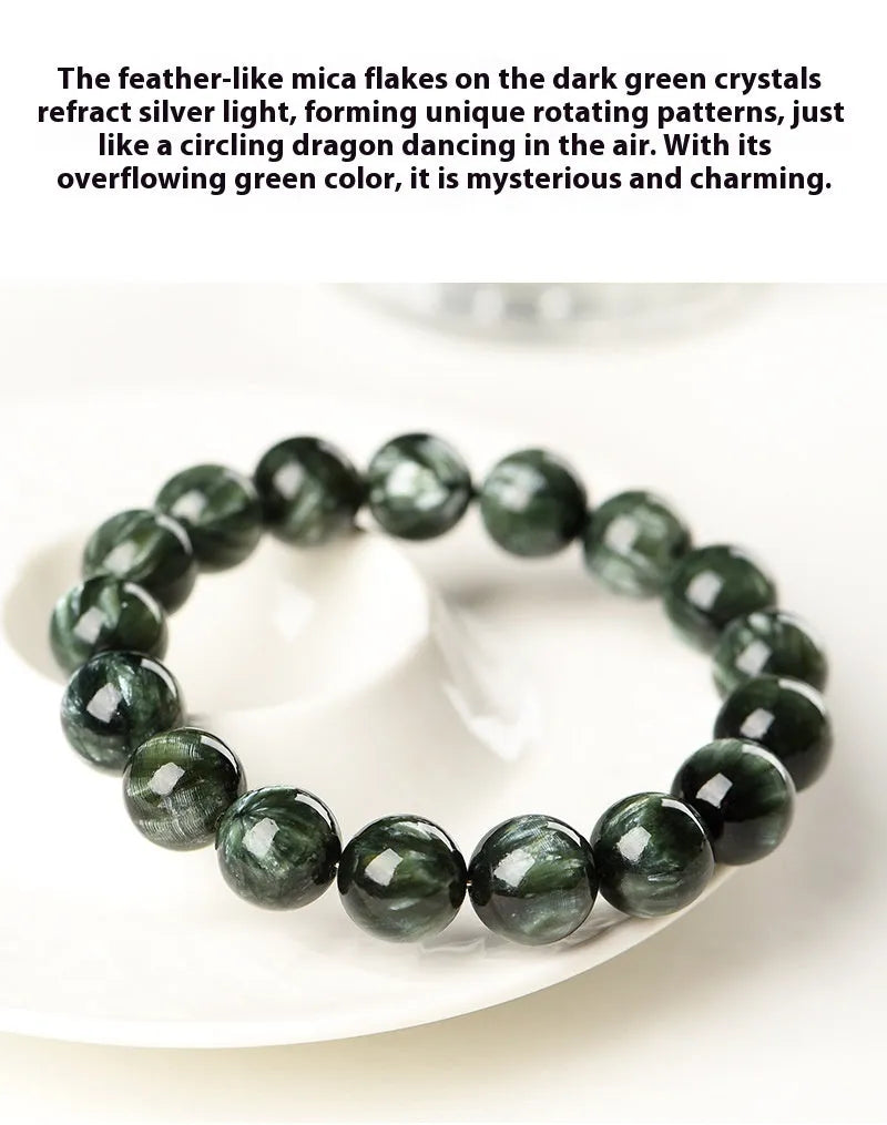 Green dragon crystal bracelet with round beads and a ruyi charm on a wrist.
