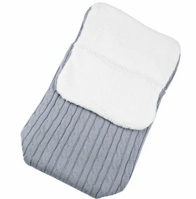 Envelope-style baby stroller sleeping bag in a plain colour, shown on a pram with lamb cashmere lining visible.