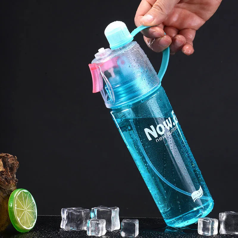 Green portable sports mist spray cup with handle, spray nozzle, and visible water level scale.