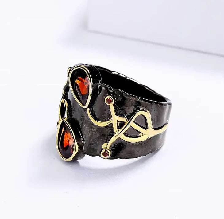 Retro women's straight-pull oval ring in brass with black finish, side view on light background
