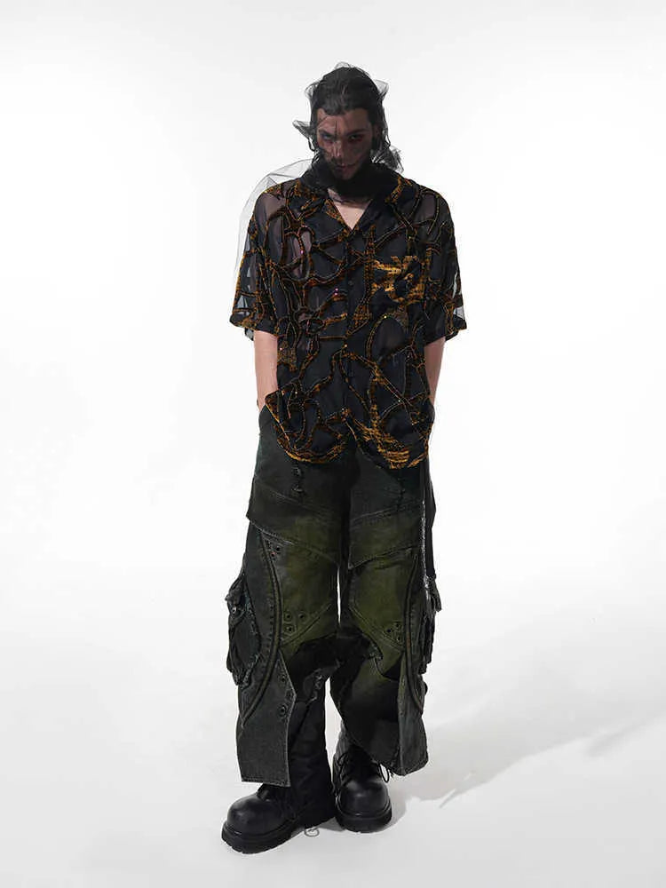 Man's black and grey snake pattern short-sleeved shirt with loose fit and lapel collar.