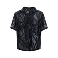 Man's black and grey snake pattern short-sleeved shirt with loose fit and lapel collar.
