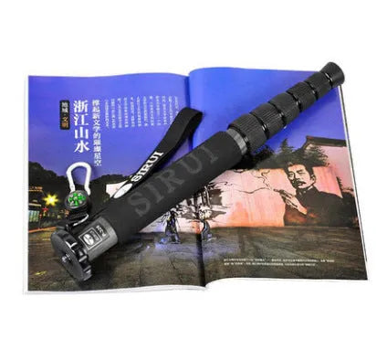 Black carbon fibre SLR camera monopod with telescoping legs extended.