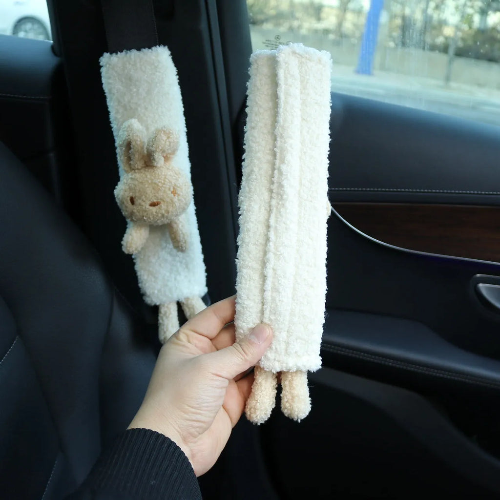 Cartoon plush lamb's wool shoulder protector for car seat belt in rabbit and bear designs.
