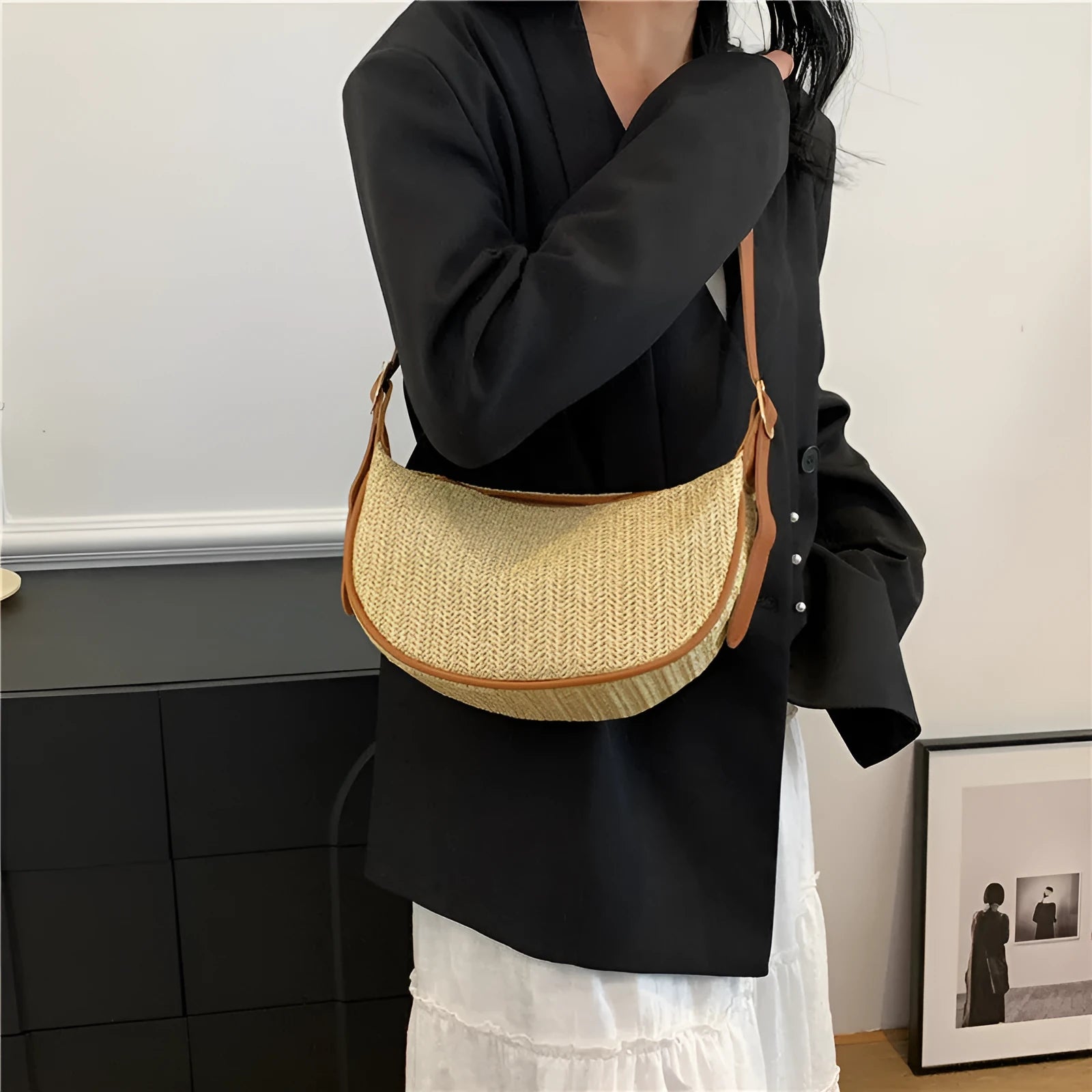 Women's straw woven crossbody bag showing woven texture and adjustable strap with internal phone and document pockets