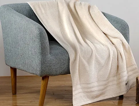 Cotton towel set showing bath, hand and face towels in beige or brown colours
