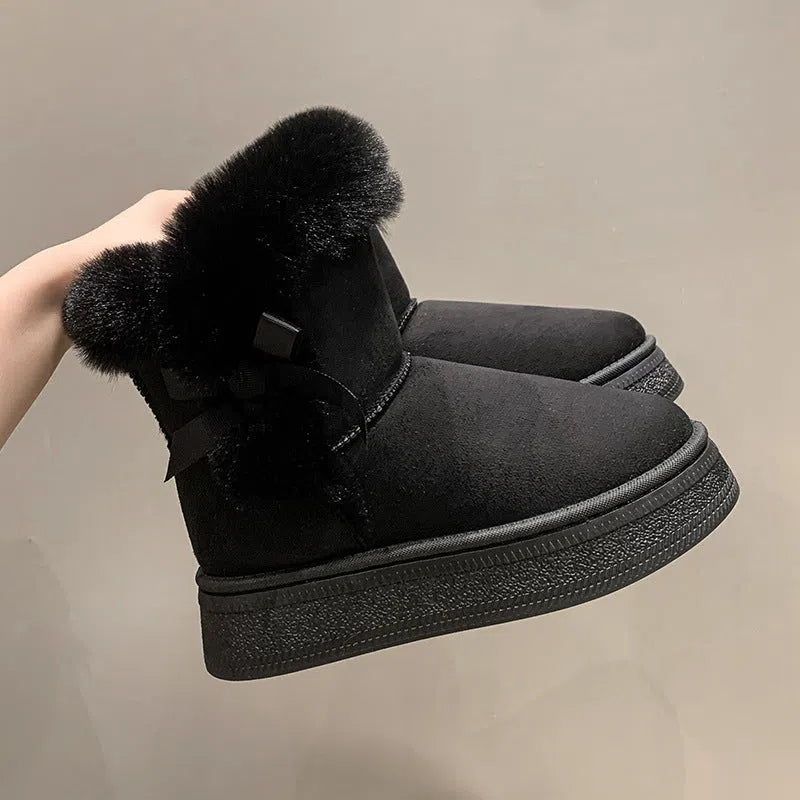 Women's mid-calf suede snow boots with faux fur lining, 1–3 cm thick rubber sole, and bow tie detail, shown in brown, black, or white.