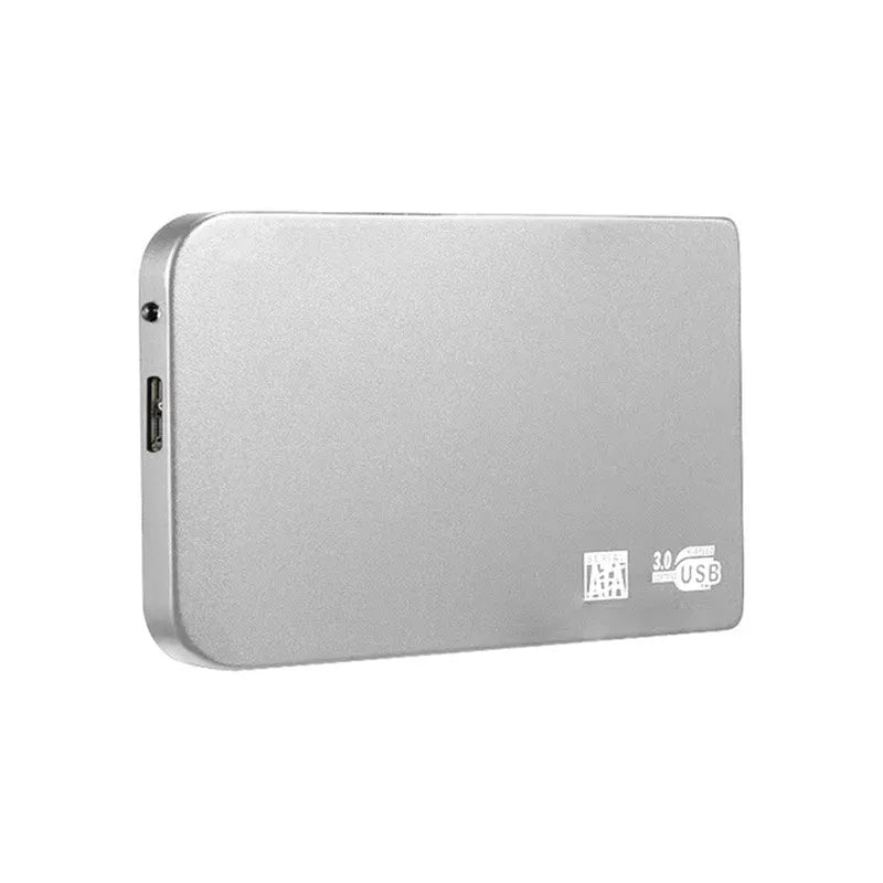 Silver portable solid state drive with USB cable and cover on a desk.