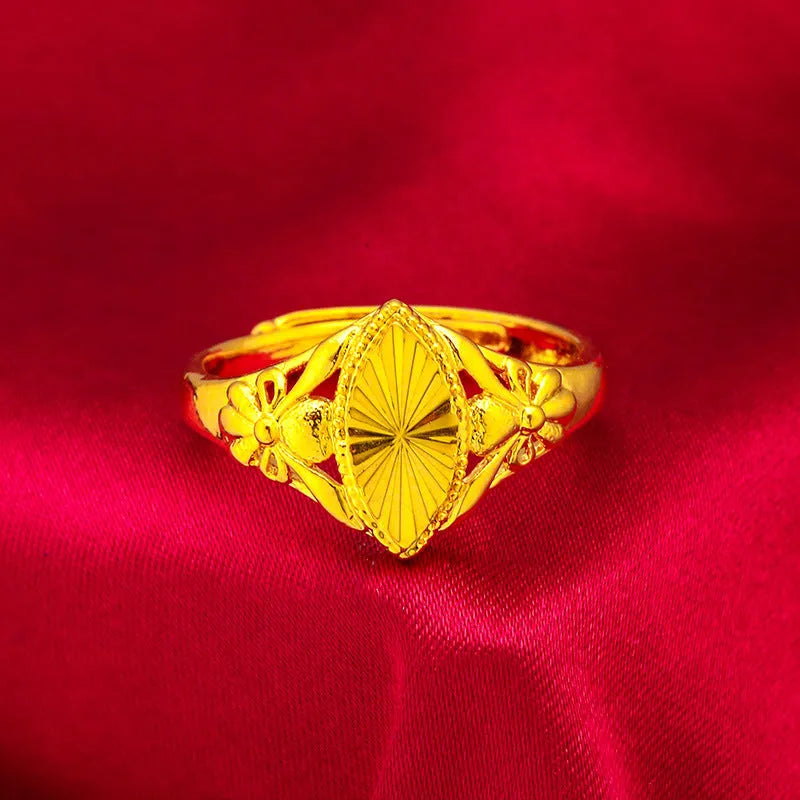 Gold-coloured brass ring with geometric open diamond flower pattern and textured surface