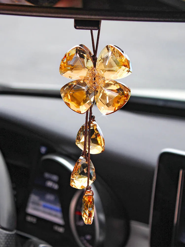 Crystal four leaf clover car pendant hanging, approximately 20 cm long, on a transparent background.