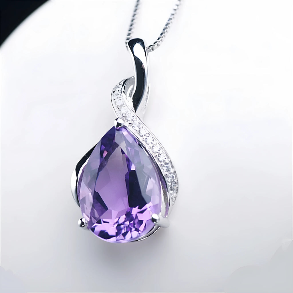 Copper drop shape pendant necklace with electroplated finish on a dark blue diamond square chain
