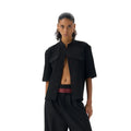 Handmade black half-sleeve shirt with a shirt collar and single-breasted front, shown in a loose fit.