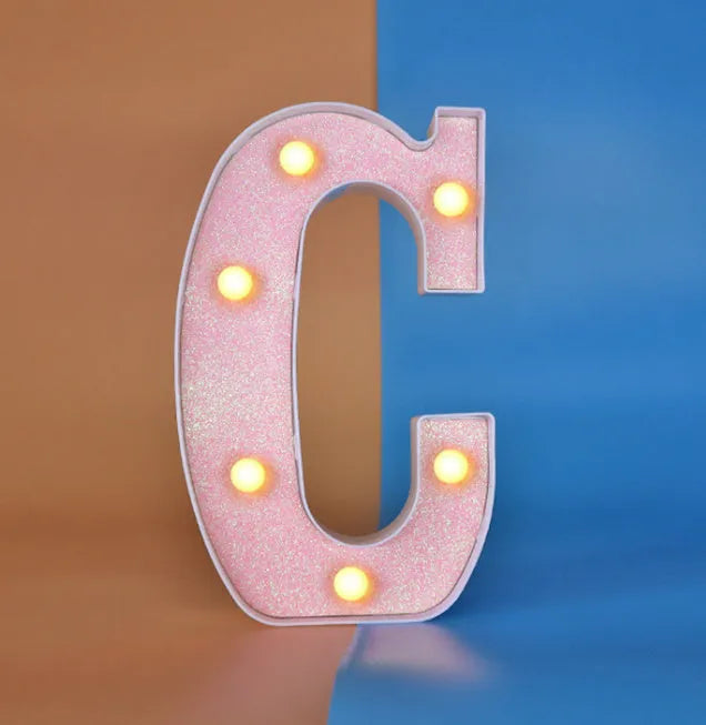 22cm LED letter light in plastic, battery operated, IP44 rated, shown as a letter for birthday party scene decoration