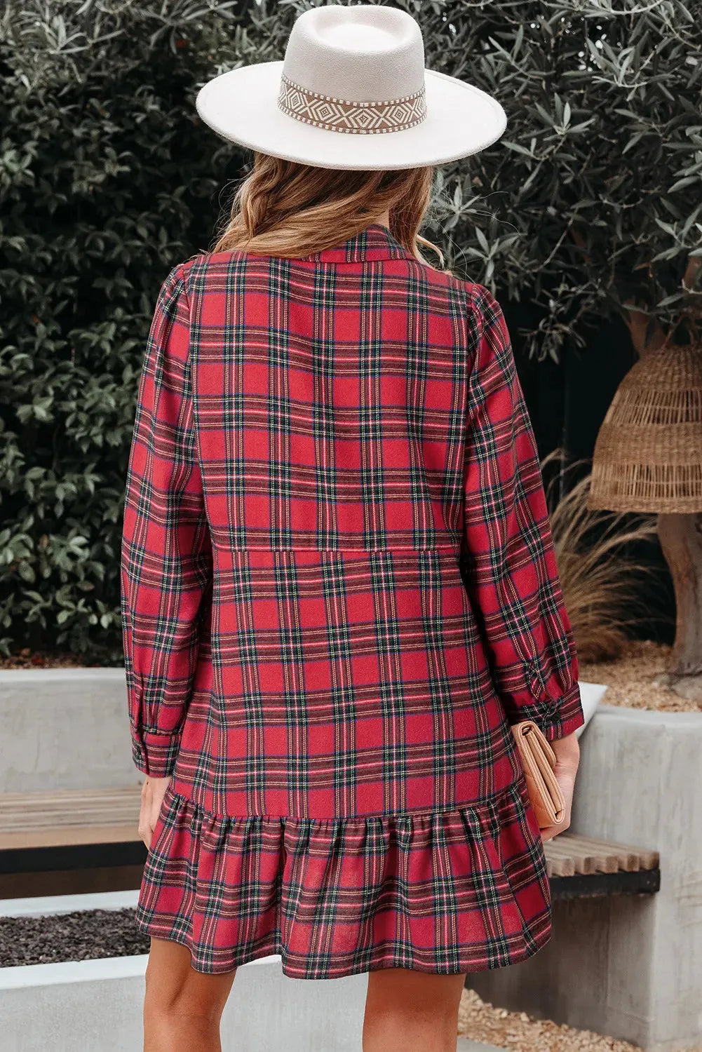 Red plaid patterned women's mini dress with a shirt collar, long sleeves, half-button front, and a ruffle hem.