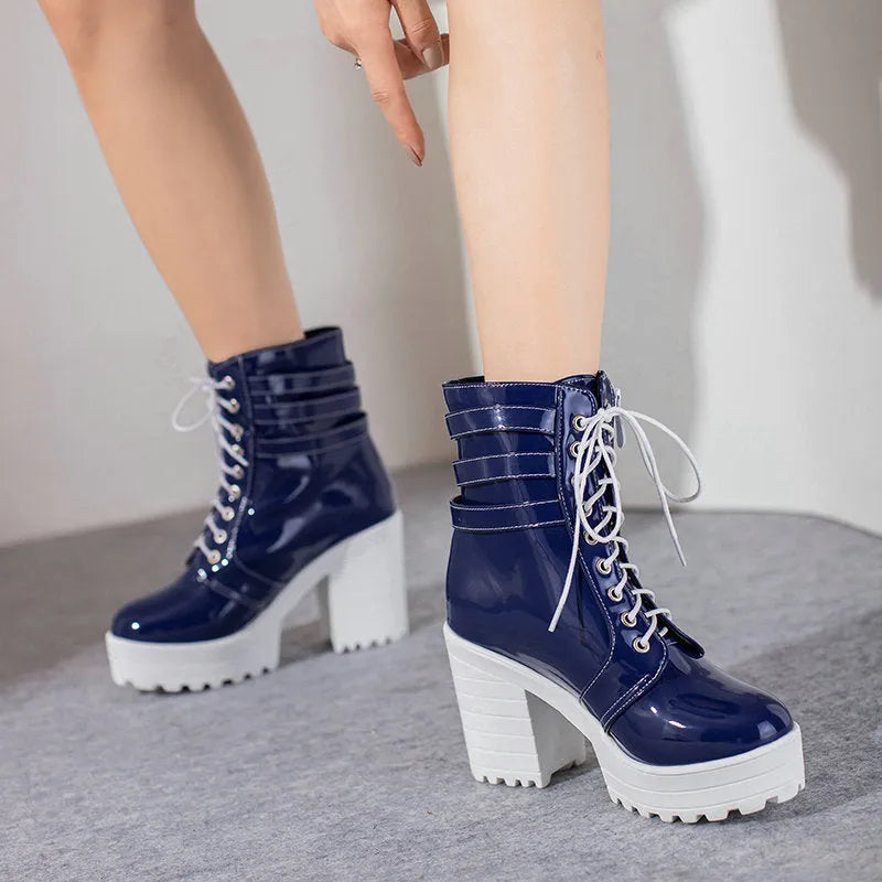 Women's black thick-heel ankle boots with lace-up front and round toe on a rubber sole.