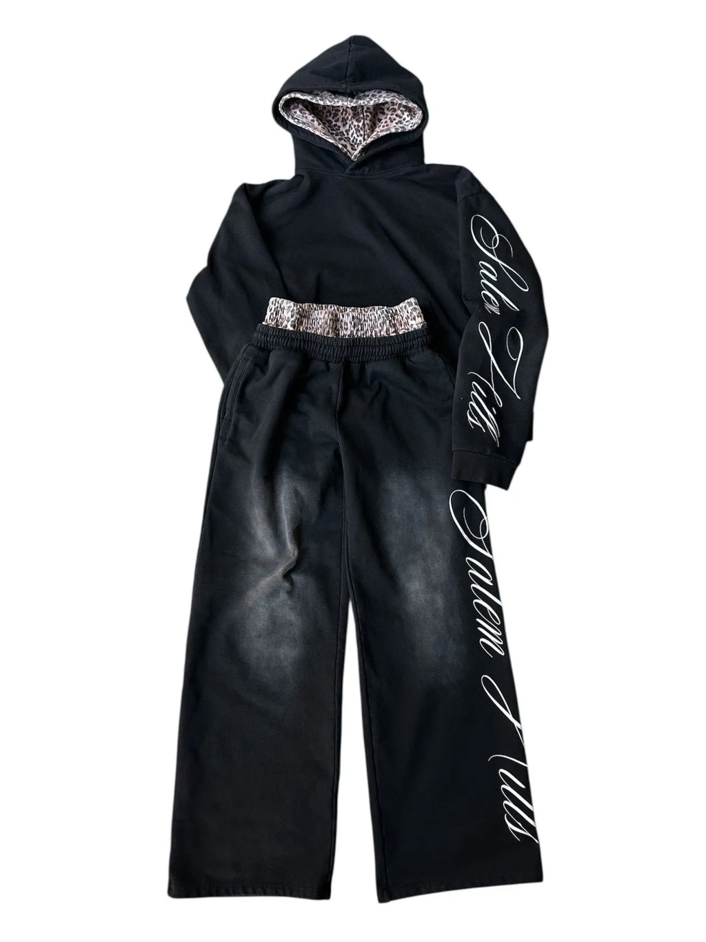 Men's black punk print pullover hoodie and matching trousers fleece-lined suit set laid flat.