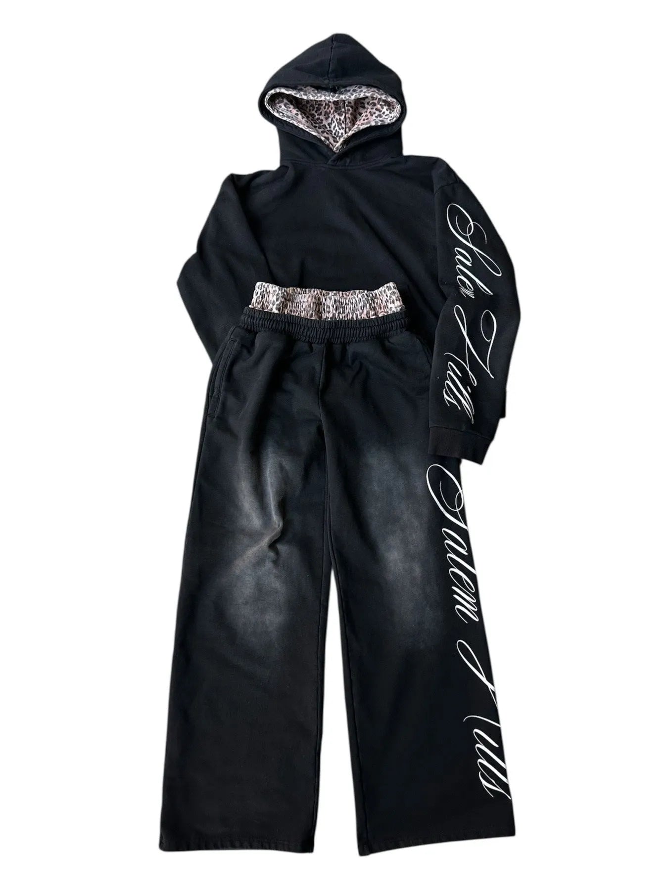 Men's black punk print pullover hoodie and matching trousers fleece-lined suit set laid flat.