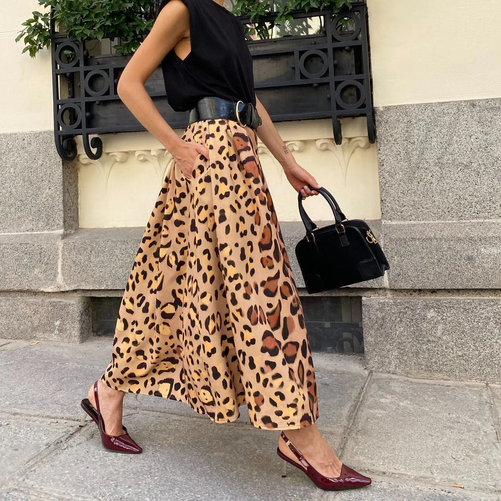 Brown leopard print women's A-line long skirt with a large hem, shown on a hanger.