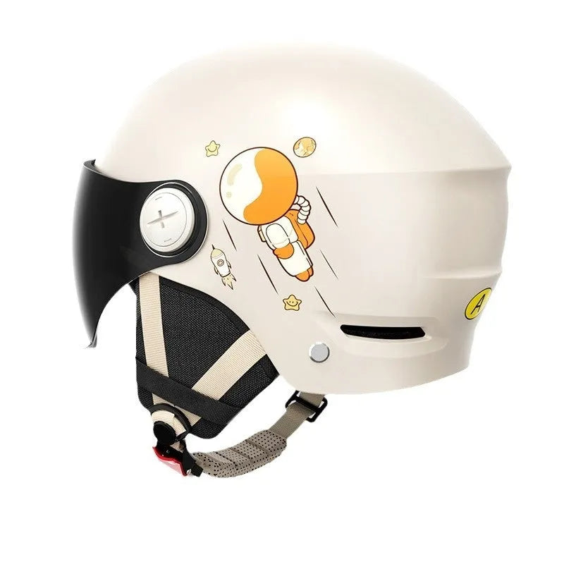 Khaki-coloured electric motorcycle half helmet with attached long glasses on a grey background.