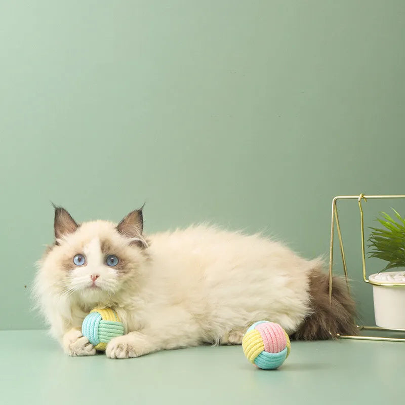 Handmade small blue powder and green plush cotton ball cat toy for teeth grinding.