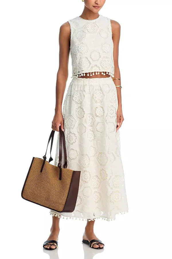 White women's retro style two-piece suit with sleeveless top, long skirt, and embroidery detail.