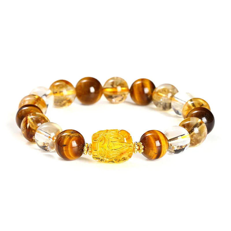 Natural yellow tiger's eye and citrine bracelet with 10mm round beads and a silver pi xiu charm on a wrist.