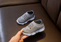 Children's white lazy slip-on shoe with fabric upper and textured non-slip rubber sole.