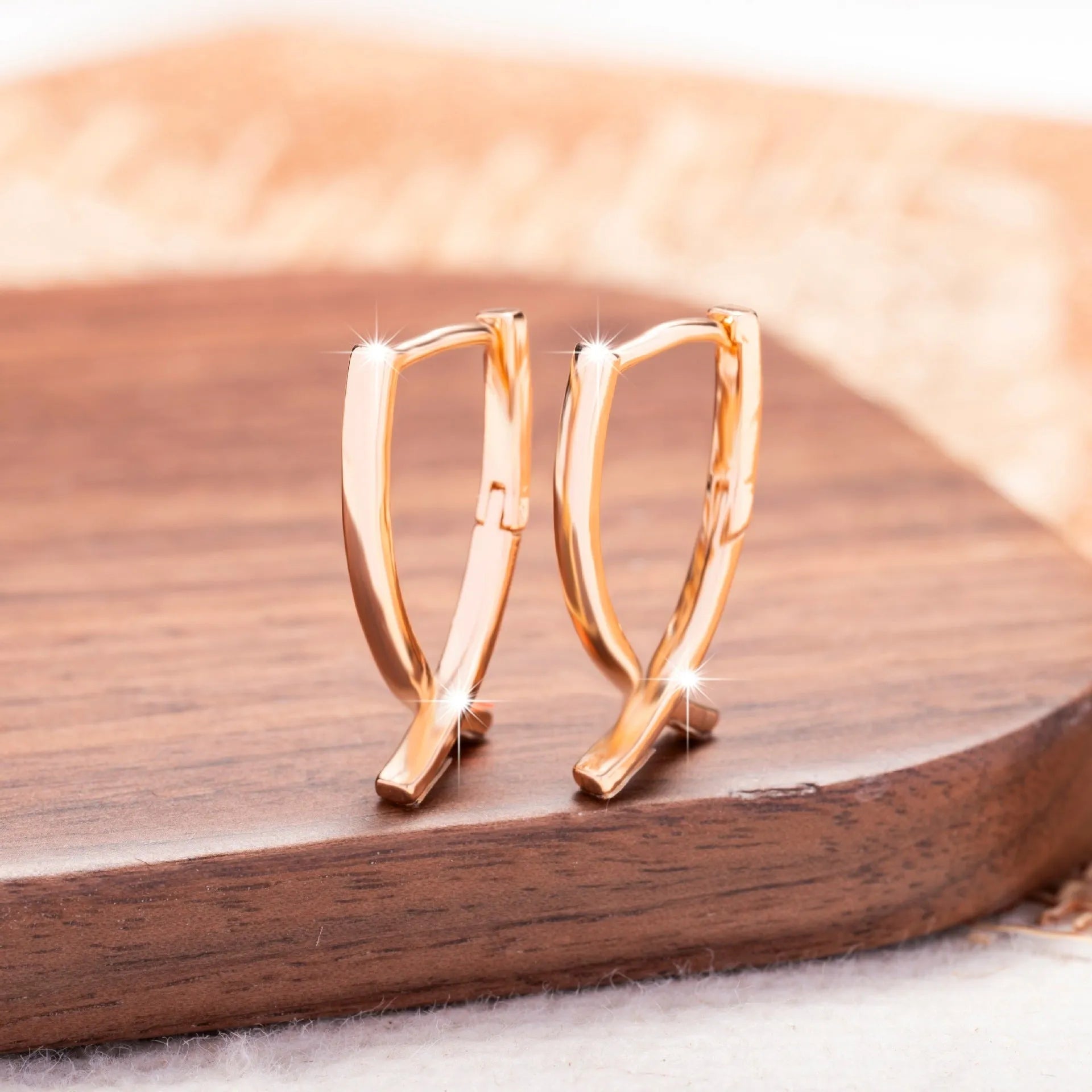 Rose gold cross shaped earrings on a copper base, light luxury style