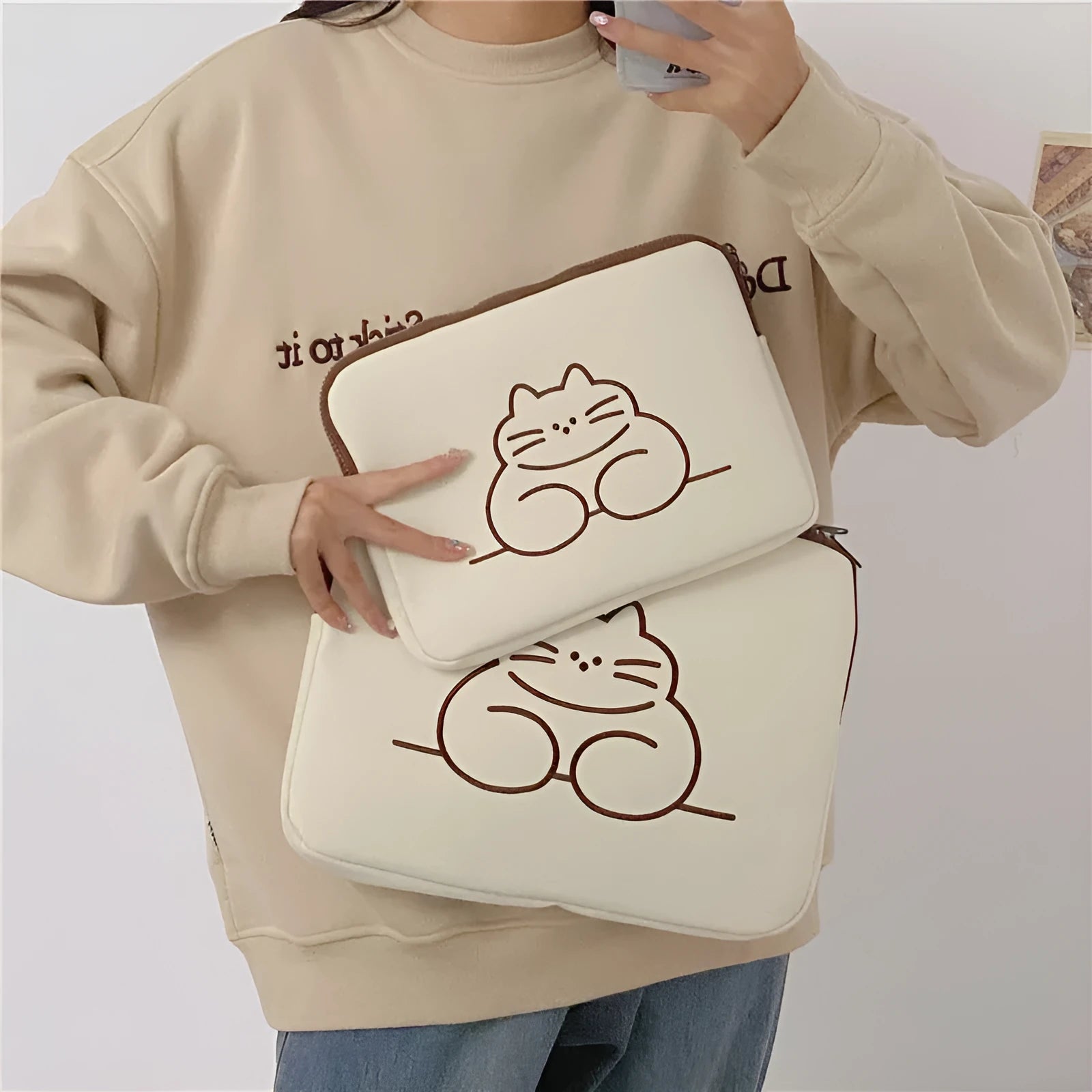 Embroidered animal design on a nylon protective sleeve bag for tablets with a zipper.