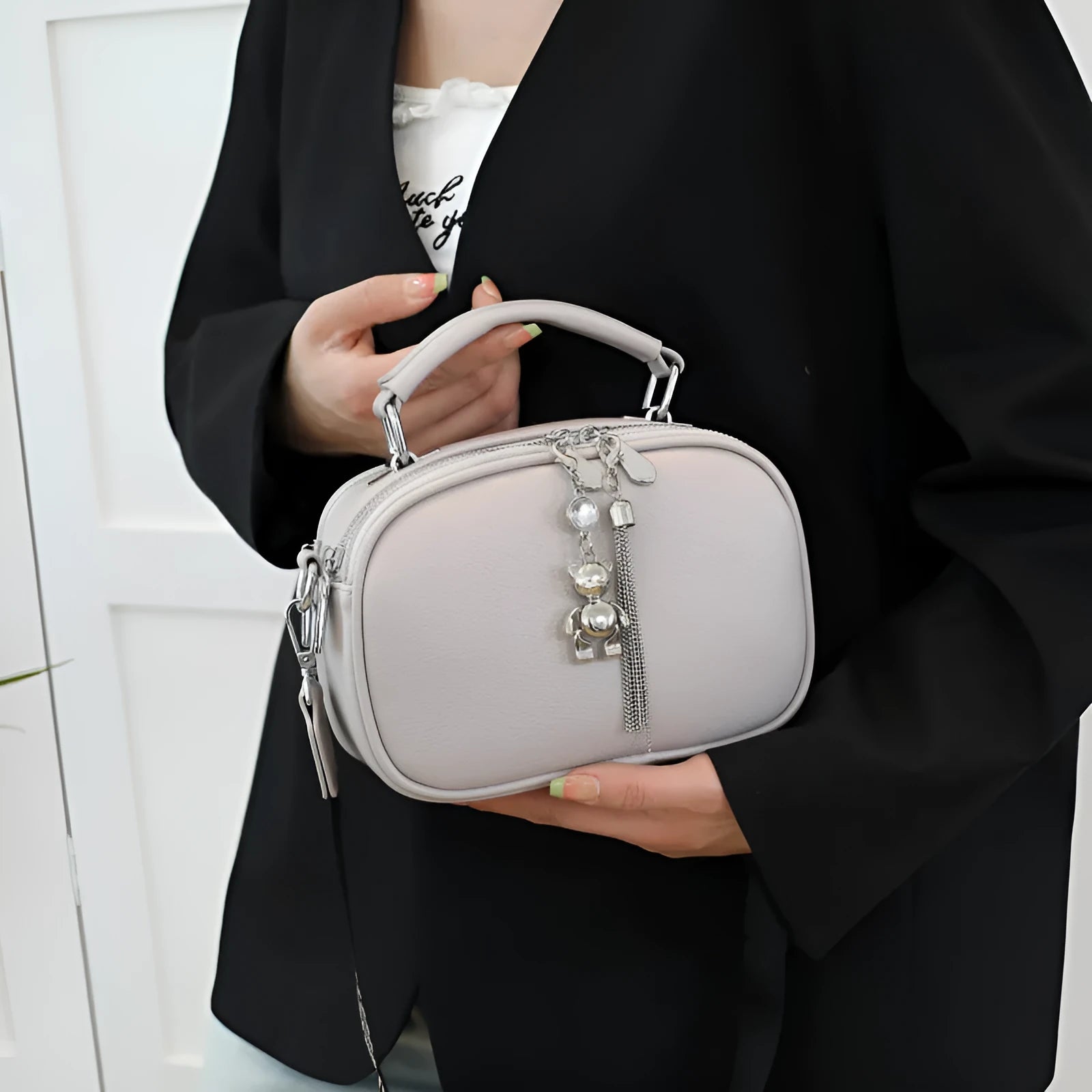 Women's small square stitching bag in PU material showing oval shape and double shoulder straps
