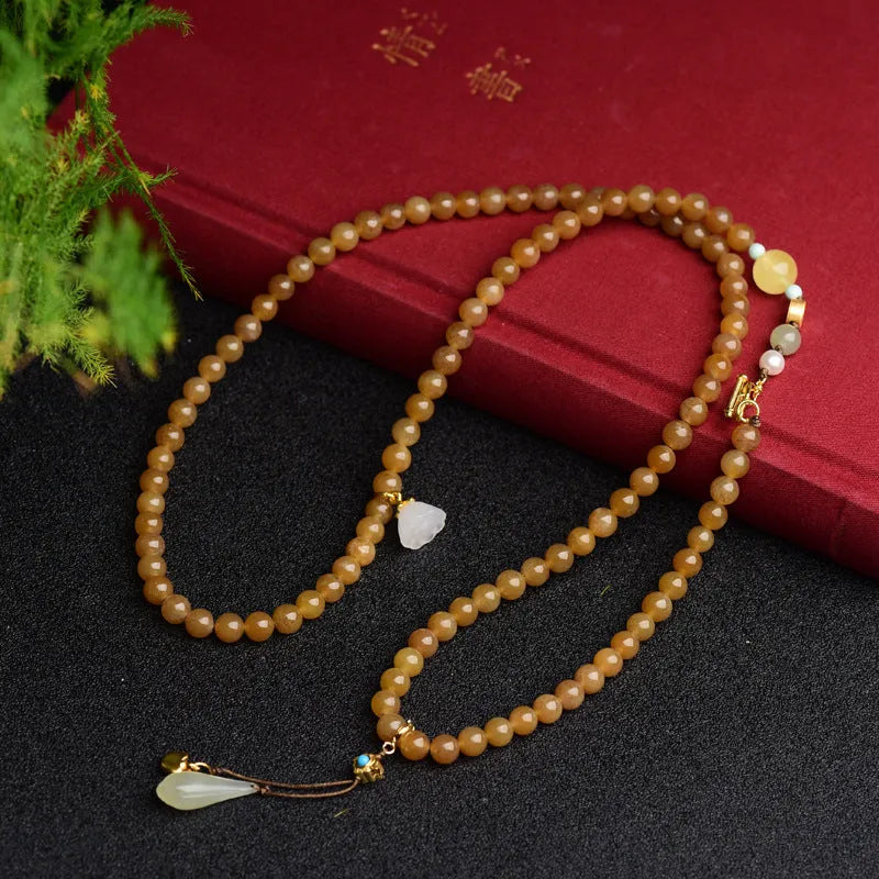 Women's water green pine jade bracelet with 6mm round beads and leaf-shaped sequin details.