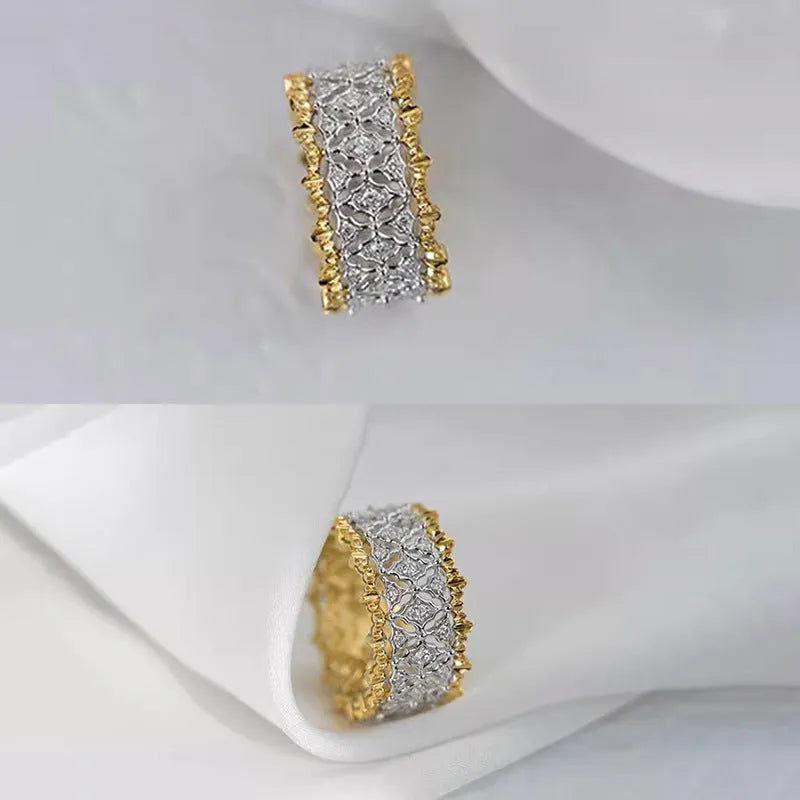 Geometric two-tone copper ring with a round central zircon stone, shown on a finger.