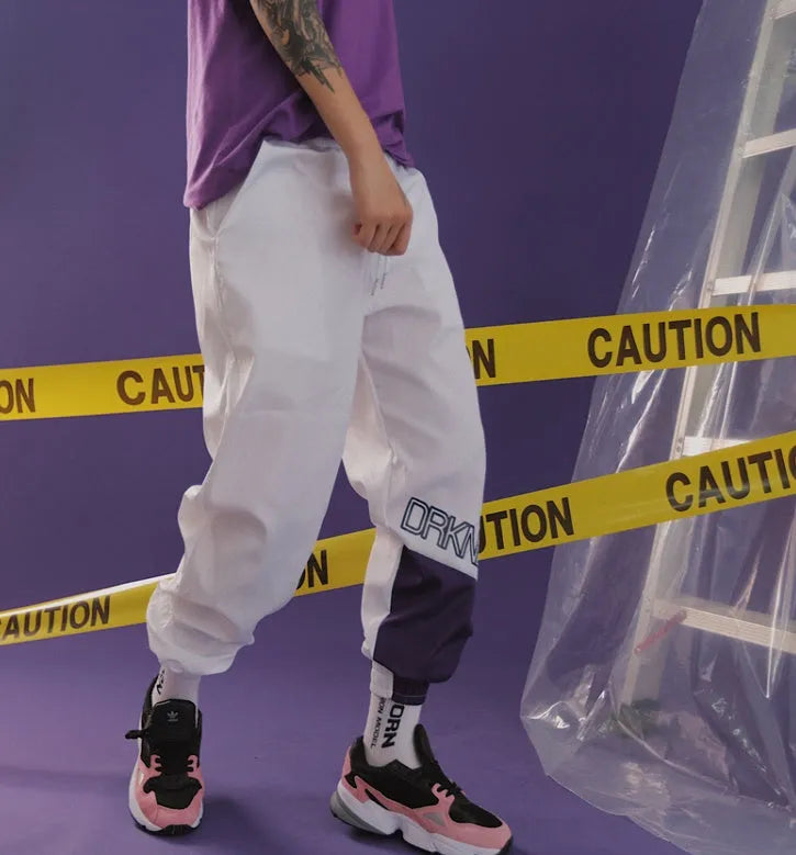 Green Japanese hip hop sweatpants with hit colour stitching, letter print, and bouquet floral design on a low-waist drawstring style