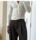 Cream-coloured men's ribbed long-sleeve henley top with a five-button placket.